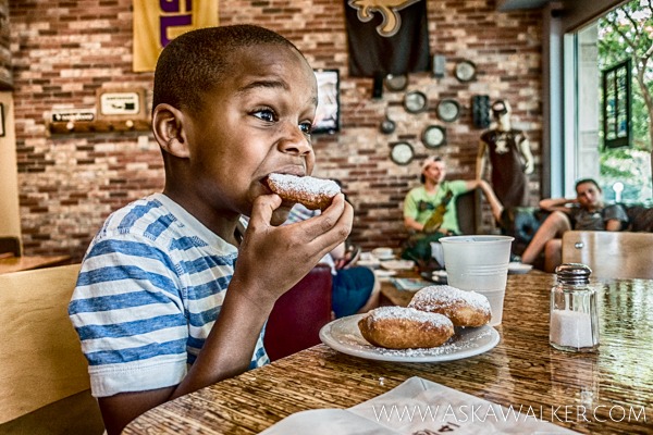 Eight Year Old Boy Eating a Beignet at Bayou Bakery